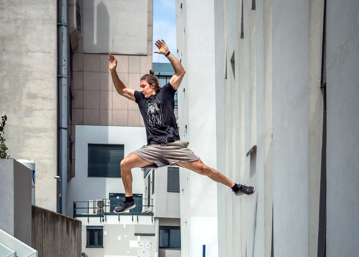Wall run in a narrow alley between two buildings