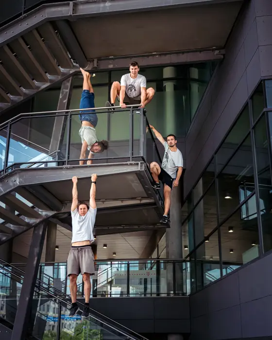 Parkour group climbing in an open stairwell